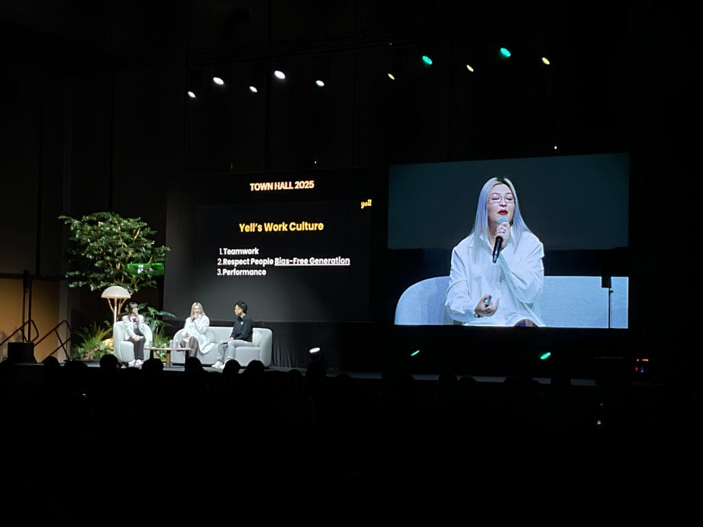 Speaker discussing workplace culture and teamwork at People Performance Conference 2026.